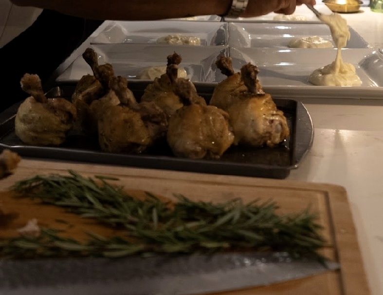 Guests seated at a private AMBĪANCE dinner, being served at the table