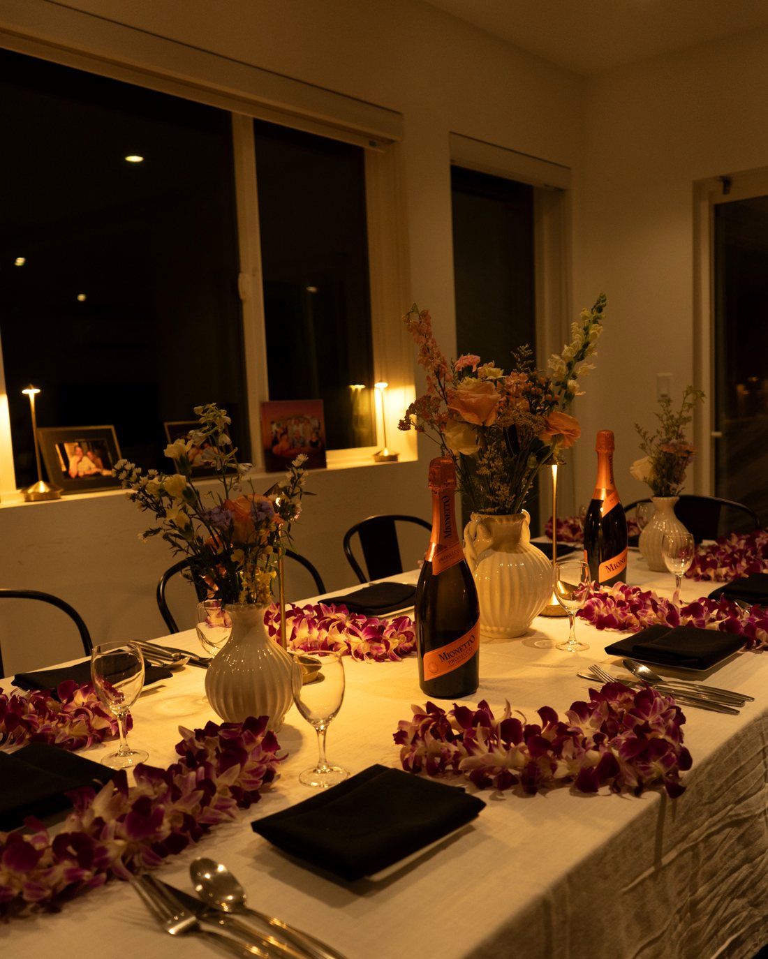 A private AMBĪANCE table set for dinner with flowers and candles